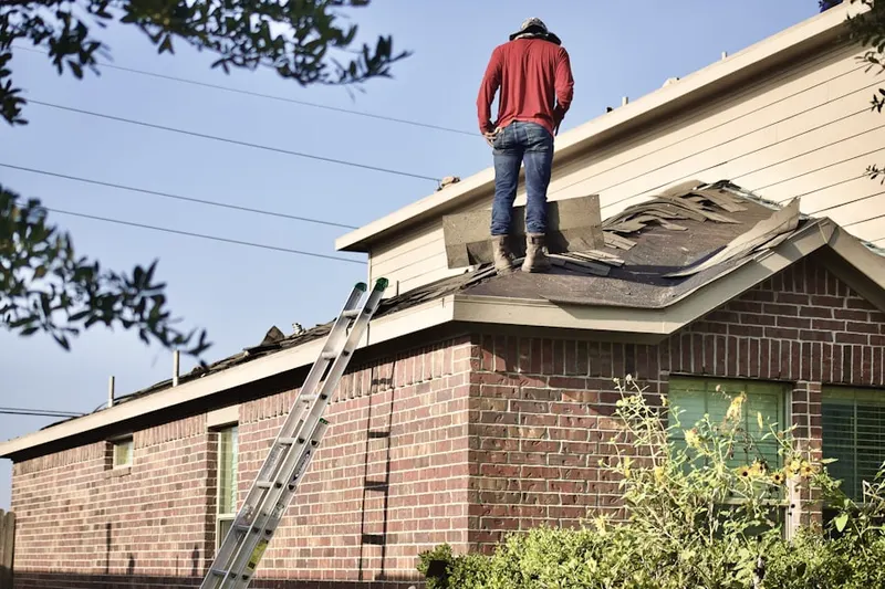 Professional roofer working on a residential roof in Concord Chase
